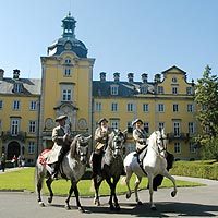 Riders from Bückeburg's Royal Court Riding School against the backdrop of the castle